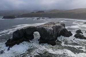 Images Dated 20th June 2019: The cold, nutrient-rich waters of the Pacific Ocean wash a natural arch set off the rugged yet