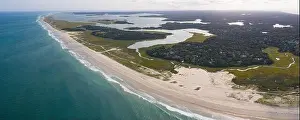 The cold water of the Atlantic Ocean washes onto a beautiful sandy beach on Cape Cod, Massachusetts. This scenic peninsula is a popular vacation area