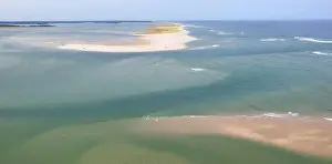 The cold water of the Atlantic Ocean washes onto a beautiful sandy beach on Cape Cod, Massachusetts. This scenic peninsula is a popular vacation area