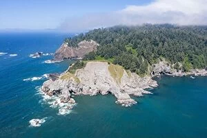Aerial Landscape Collection: The cold water of the Pacific Ocean meets the rugged yet beautiful coastline of Oregon just north
