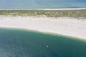 The cold waters of the Atlantic Ocean bathe a scenic beach on Cape Cod, Massachusetts. This beautiful part of New England is a popular vacation area