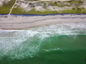 The cold waters of the Atlantic Ocean washes onto Nauset Beach in Orleans, Massachusetts. This beautiful Cape Cod beach is a popular destination