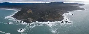 The cold waters of the Pacific Ocean beat against the rocky coastline of Northern California. The Pacific Coast Highway runs along this scenic region