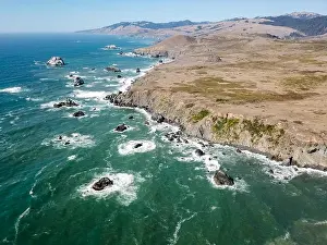 The cold waters of the Pacific Ocean wash against the scenic and rugged coastline in Sonoma, California