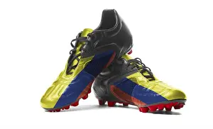Against White Background Prints: The Colombian flag painted on football boots. Isolated on white background