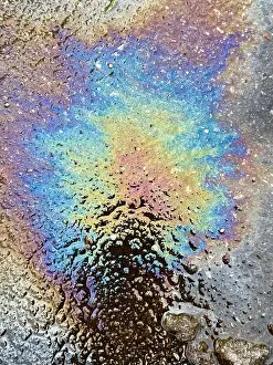 Petroleum Prints: Color burst oil slick on wet pavement from a car