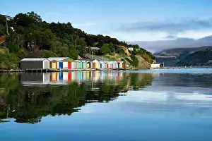 Shed Prints: Colorful Boat Sheds with beautiful reflection on daytime at Duvauchelle