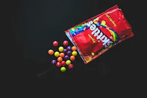 Sweetener Prints: Colorful candy Skittles on the black background taken from the top