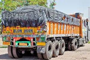 Gujarat Prints: Colorful Indian heavy goods vehicle parked up at Dhabha (Indian truck stop) in the mid day sun