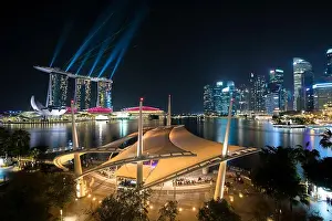 Colorful Singapore skyscraper building and laser show in night at Singapore