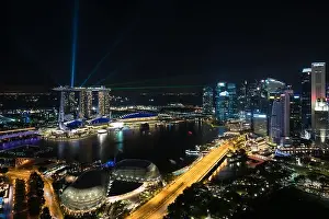 Colorful Singapore skyscraper building and laser show in night at Singapore