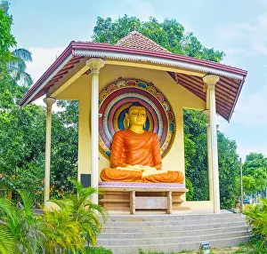 Maha Prints: The colorful statue of Meditating Buddha surrounded by greenery of Halpanwila Temple garden