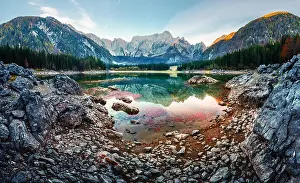 Colorful sunrise on Fusine lake. Picturesque autumn scene with Mangart peak on background. Julian Alps, Udine Province, Italy