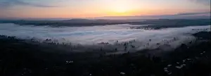A colorful sunrise illuminates a layer of fog that covers the scenic Willamette River not far south of Portland, Oregon