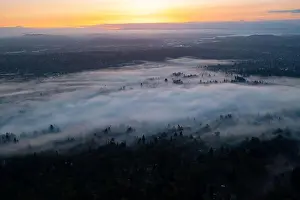A colorful sunrise illuminates a layer of fog that covers the scenic Willamette River not far south of Portland, Oregon