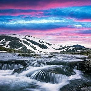 Images Dated 8th July 2017: Colorful sunrise on snowy norwegian mountains and clear river near the famous Aurlandsvegen