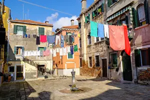 Patina Prints: Colourful laundry hanging on clothes lines in a campiello Venice Italy