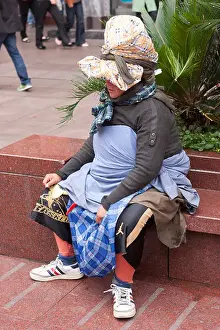 Homeless Prints: A colourful, stylish, inventively dressed, bag lady in Nanjing Dong Lu, Shanghai, China