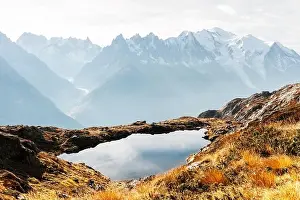 Colourful sunset on Chesery lake (Lac De Cheserys) in France Alps. Monte Bianco mountain range on background