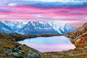 Colourful sunset on Chesery lake (Lac De Cheserys) in France Alps. Monte Bianco mountain range on background