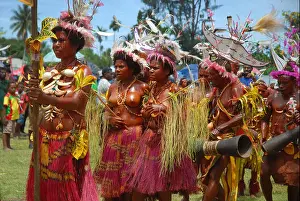 Papua New Guinea Prints: Colourfully dressed and face painted women dancing as part of a Sing Sing in Madang