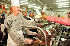 Camaraderie Prints: Command Sgt. Maj. Stephan Frennier serves Thanksgiving dinner to soldiers and civilians at Camp Arifjan