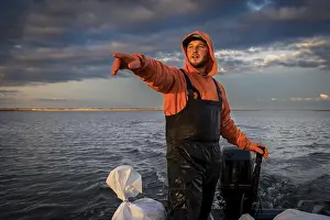 Motor Boat Prints: Commercial fisherman in boat pointing to something in the distance