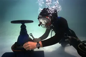 Mask Prints: commercial oil rig diver at work underwater on valve in north sea