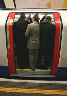Packed Prints: commuters on London Underground squeeze on to the train