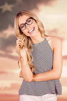 American Flag Prints: Composite image of gorgeous smiling blonde hipster playing with hair