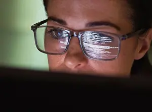 Mid Adults Prints: Computer programmer wearing eyeglasses looking at codes