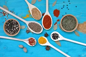 Paprika Prints: Concept of table with colorful spices in wooden spoons and bowls
