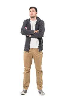 Sneakers Prints: Confident casual man with crossed arms looking up wearing gray zip sweater