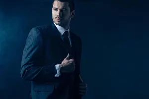 Mafia Prints: Confident mafioso looking away on dark blue background