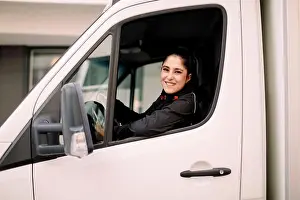 25 29 Years Prints: Confident young delivery woman driving truck