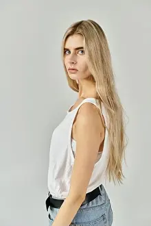 Casual Clothes Prints: A confident young woman showcases her long blonde hair and casual style in a stylish studio setting