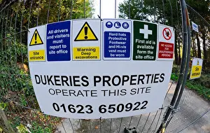 Construction warning and safety signs at the entrance to a construction site