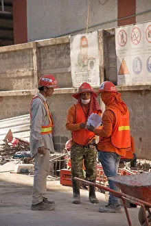 Workwear Prints: Construction workers wearing safety equipment at an outdoor meeting