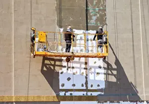 Refurbish Prints: Construction workers working on side of house