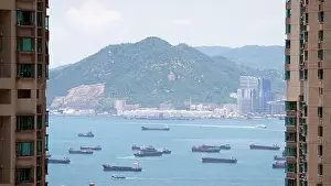 Cargo Ship Prints: the empty container ships park near the Kwai Tsing port between building