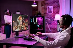 Content creator playing video games competition online at computer station, enjoying live esport tournament multiplayer game