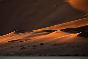 Contrasted abstract of the Oxide rich red sand dunes in the great sand sea of Namibia