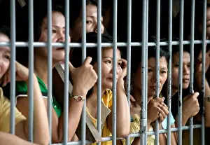 Convicted women behind bars in a communal cell in the Angeles District Jail, The Phillipines