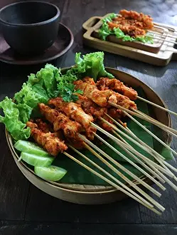 Ramadan Prints: cooking fish with curry sauce and cayenne pepper in a clay dish