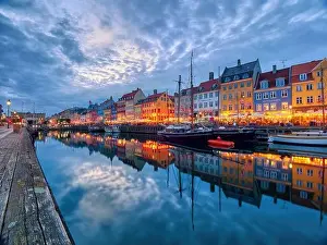Copenhagen, Denmark - July 02, 2021: Famous old Nyhavn port in the center of Copenhagen, Denmark during summer night. Copenhagen iconic view