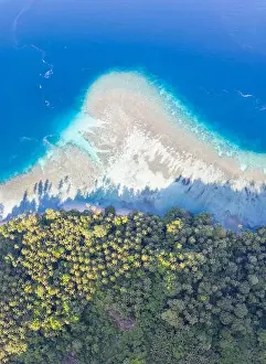 A coral reef surrounds idyllic islands near New Britain in Papua New Guinea. This area is part of the Coral Triangle due to its biodiversity