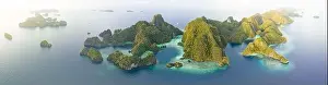 Coral reefs surround the rugged limestone islands that rise from Raja Ampat's seascape. This remote part of Indonesia has high marine biodiversity