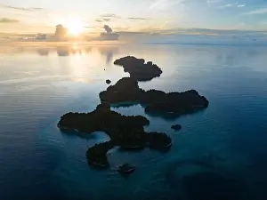 Coral reefs surround the rugged limestone islands that rise from West Papua's seascape. This remote part of Indonesia has high marine biodiversity
