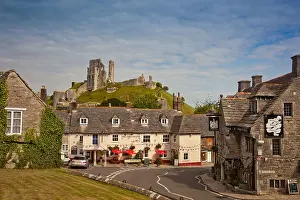 Defensive Prints: Corfe Castle ruins tower above The Greyhound pub and Bankes Arms Hotel in Corfe Castle village