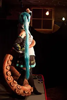 Manga Prints: Cosplay /anime performer poses onstage with a big fake octopus tentacle at a Dr Sketchy burlesque life drawing event